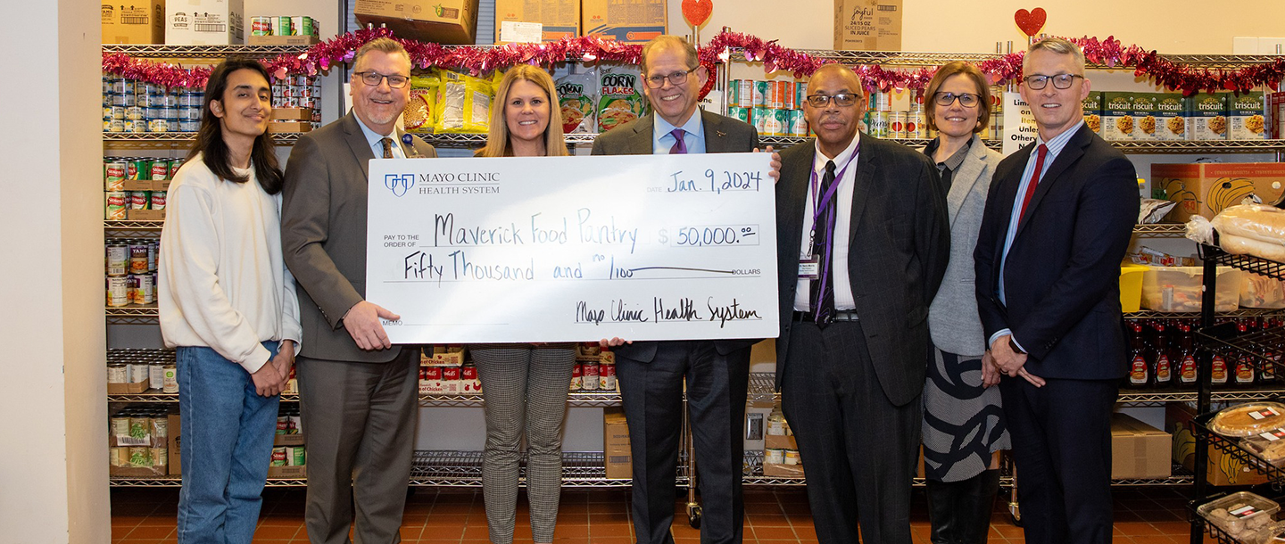 a group of people holding a large check